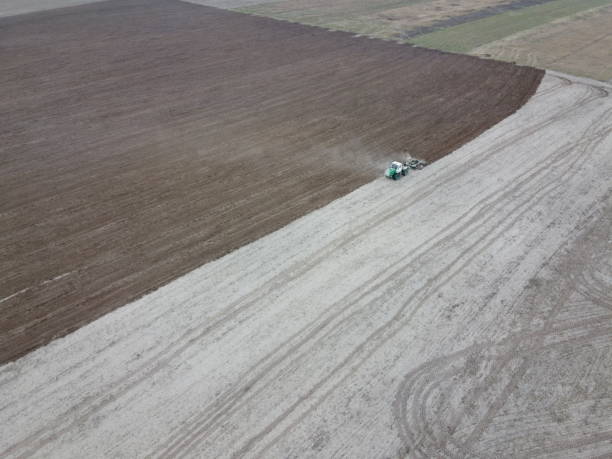istock Tractor plows a field, aerial view. Agricultural landscape. 1942673596