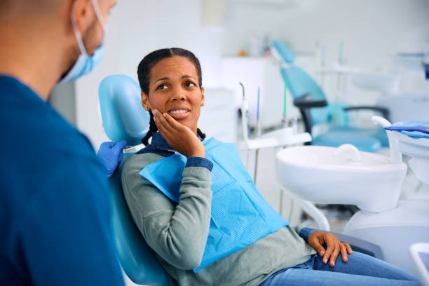istock Black woman complaining about toothache during appointment at dentist's office. 1942683144