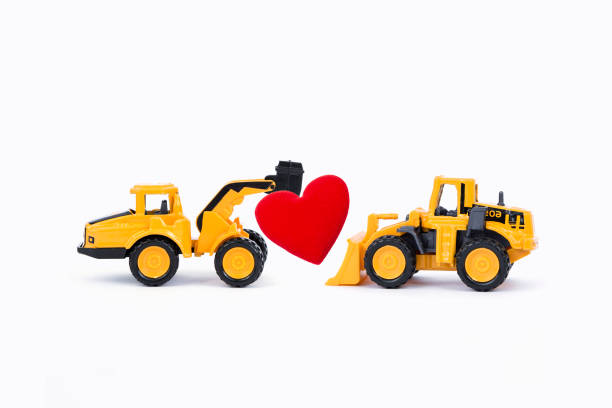 istock Two yellow truck with red heart isolate on white background 1942690610