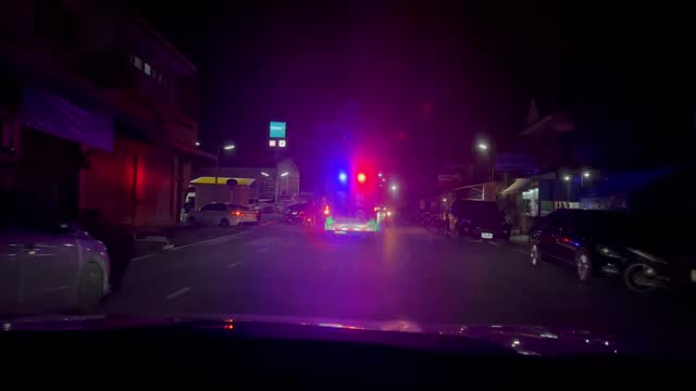 Ambulance emergency car rushing to accident scene at night