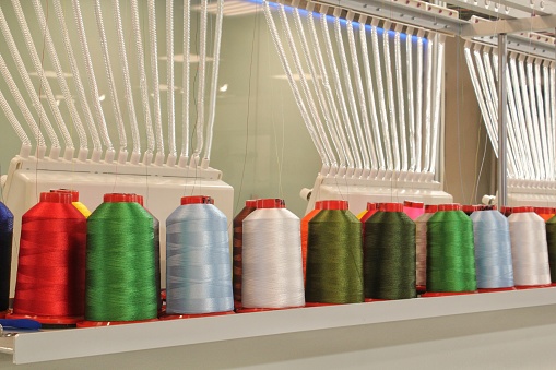 Yarn bobbins making in a textile factory.Textile Industry Concept image., wool, cotton, warping machine, thread, bobbin