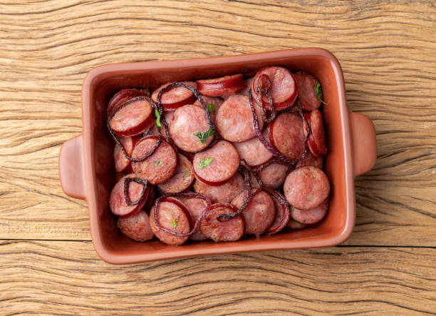 istock Grilled calabrese sausage portion with onion over wooden table 1942757656