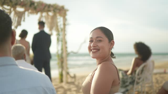 Portrait of a young wedding guest woman in a wedding ceremony on the beach