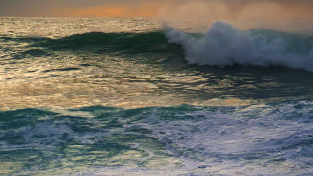 istock Morning waves swelling coast before storm. Powerful white surf rolling breaking 1942762902