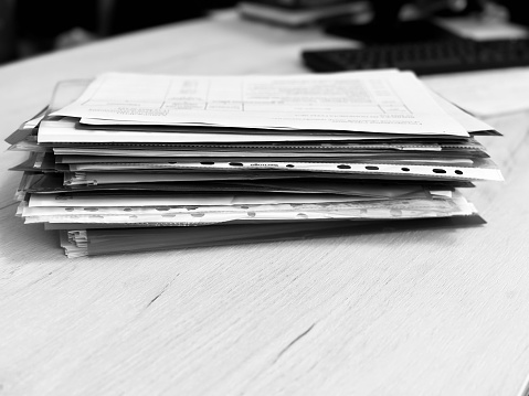 Many document papers stacked on the desktop