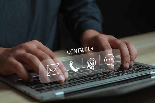 istock Businessman using virtual screen contact icon contact us or connect customer support hotline contact customer phone support online customer support concept copy space on computer screen 1942768198