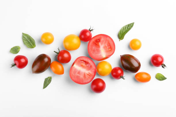 istock Flat lay composition with different whole and cut tomatoes on white background 1942787168