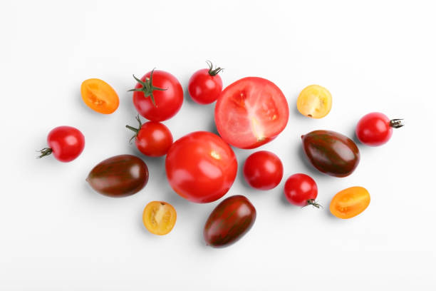 istock Flat lay composition with different whole and cut tomatoes on white background 1942787170