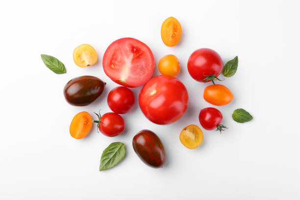istock Flat lay composition with different whole and cut tomatoes on white background 1942787181