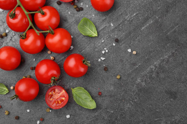 istock Ripe tomatoes, basil and spices on gray textured table, flat lay. Space for text 1942788224