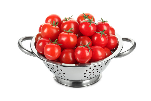 Colander with fresh ripe cherry tomatoes isolated on white