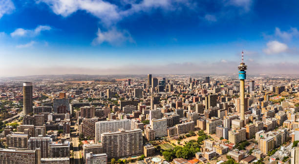 Johannesburg cityscape panorama sunrise with the residential Hillbrow suburb and the iconic Telkom communication tower to Ponte tower.