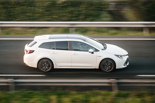 Santander, Spain - 12 January 2024: A Toyota Corolla Touring Sports in motion on a highway