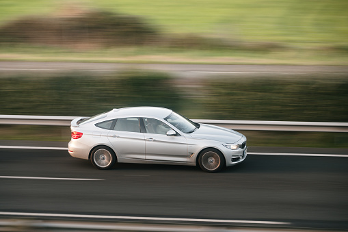 Santander, Spain - 12 January 2024: A BMW 3 Series Gran Turismo in motion on a highway