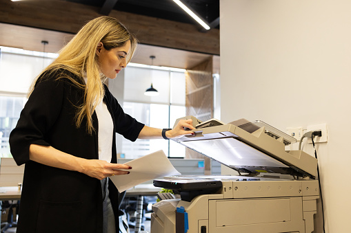Frantically Making Copies Beautiful Office Worker Using A Copy Machine To Make Copies Of ...