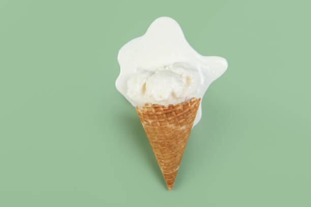 istock Melted ice cream and wafer cone on green background, top view 1942803602