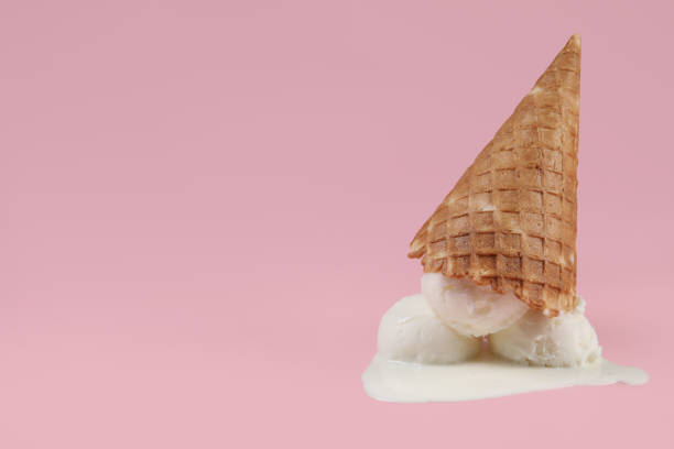 istock Melting ice cream and wafer cone on pink background, space for text 1942805741