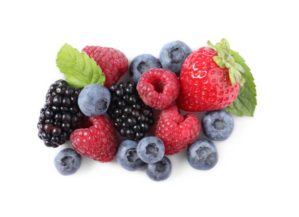 istock Many different ripe berries and mint leaves isolated on white, top view 1942806266