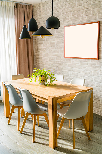Modern dining table in a small apartment illuminated by the sun. High resolution 42Mp studio digital capture taken with SONY A7rII and Zeiss Batis 40mm F2.0 CF lens