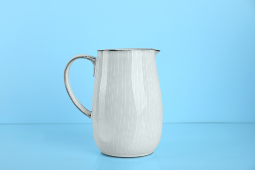 One white jug on light blue background
