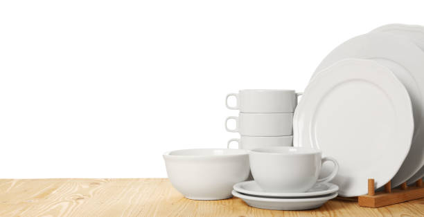 istock Set of different clean dishware on wooden table against white background 1942815799