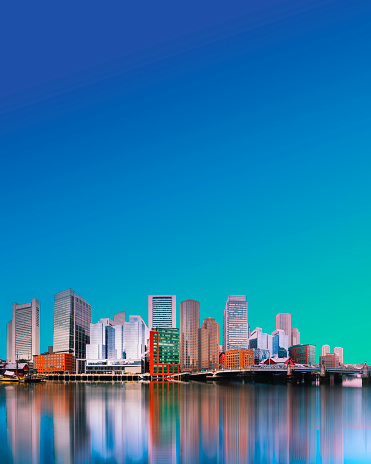 Boston City Massachusetts Skyline with skyscrapers and water reflections on the Charles River, Magazine Cover Style Backgrounds with the blue and green gradient color sky for copyspace