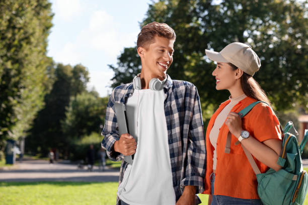 istock Happy young students spending time together in park 1942846560