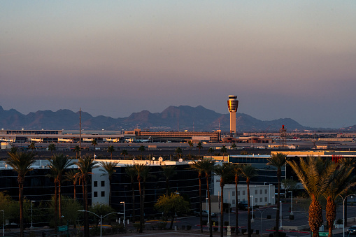 Phoenix, Arizona - December 24, 2023: Sunset at the Phoenix Sky Harbor International Airport, with the air traffic control tower in view