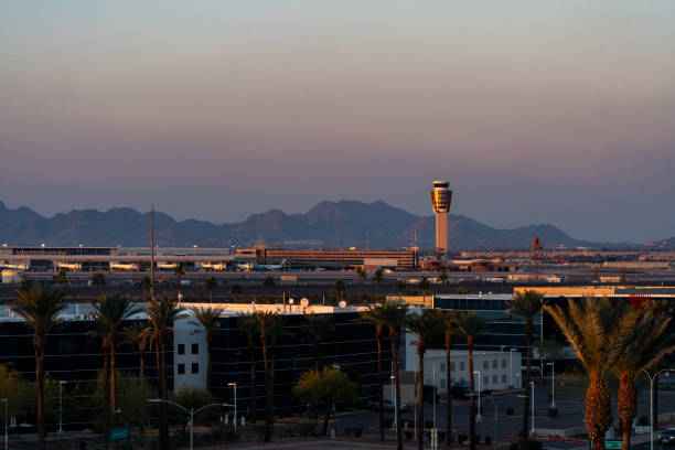 sunset at the phoenix sky harbor international airport, with the air traffic control tower in view - control harbor airport tower imagens e fotografias de stock