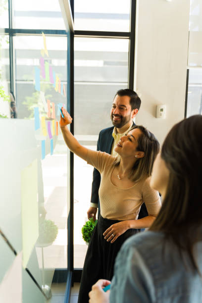 istock Group of businesspeople working in a team building activity at an office 1942865099