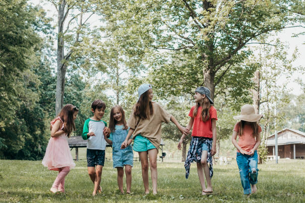 istock Group of elementary age children play outdoors during summer camp 1942875116