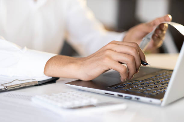 istock accountant checking invoice, accountant calculating expenses, savings 1942896976