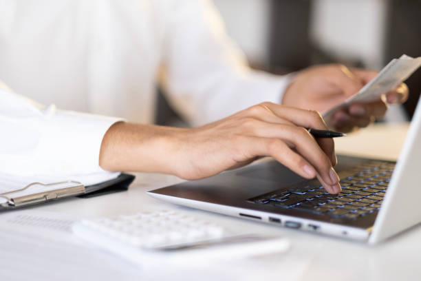 istock accountant checking invoice, accountant calculating expenses, savings 1942896979
