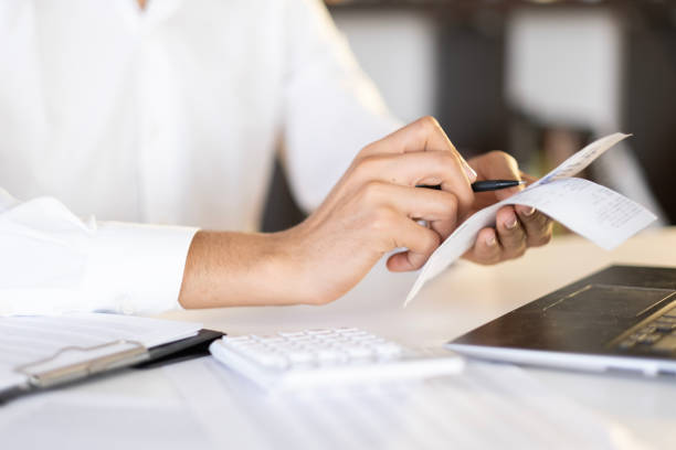 istock accountant checking invoice, accountant calculating expenses, savings 1942897492