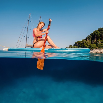 Woman paddling on a stand-up paddleboard