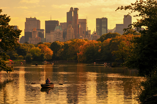 Row boats at sunset on a small lake at the Central Park, Upper West Side, New York City, NY, USA.