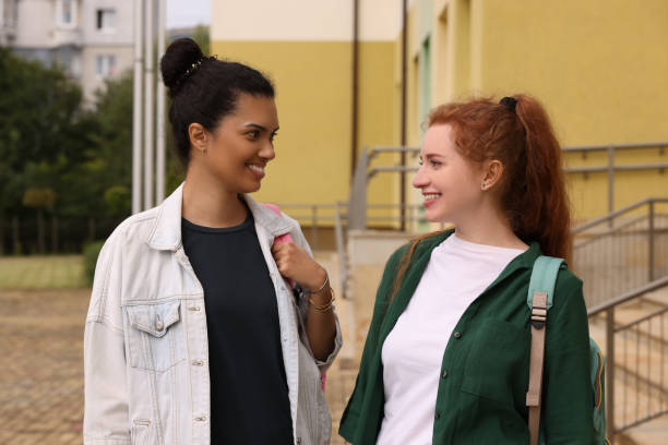 istock Happy young students spending time together outdoors 1942943986