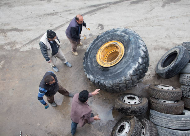 Karaman,Turkey,November 13, 2017:People repairing a giant construction machine tire.