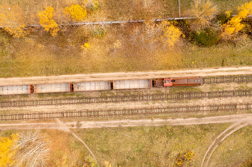 Drone photography of empty train near a industrial complex during autumn sunny day