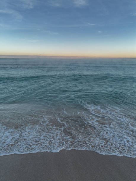 istock Beach shore wave background with the sunrise on the horizon 1942953762