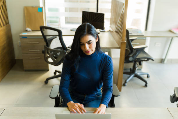 istock Portrait of a beautiful Latin woman using a laptop computer for work 1942955344