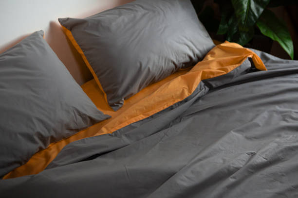 istock crumpled two-color bed linen on the bed 1942956371