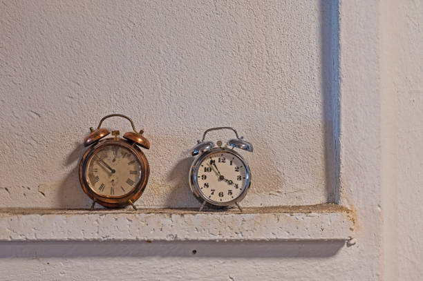 istock German and Czech alarm clocks on an old wall. 1942957434