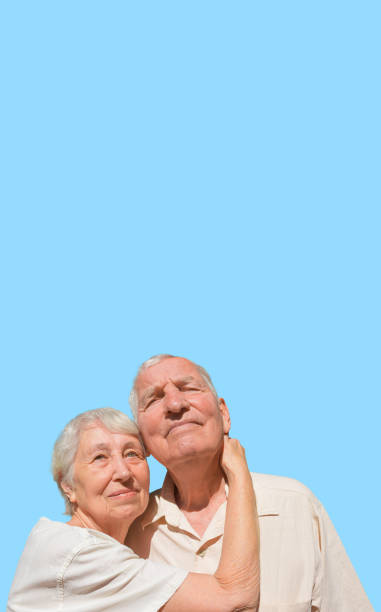 istock Elderly couple portrait. Isolated on blue background 1942964057