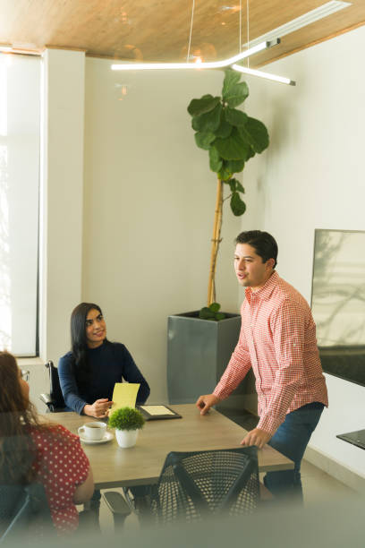 istock Good looking Caucasian boss talking to his team during a meeting 1942969853