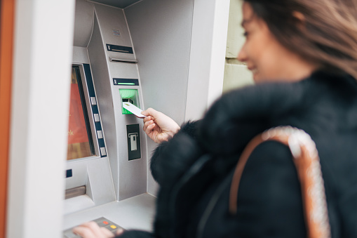 Young woman using a cash machine