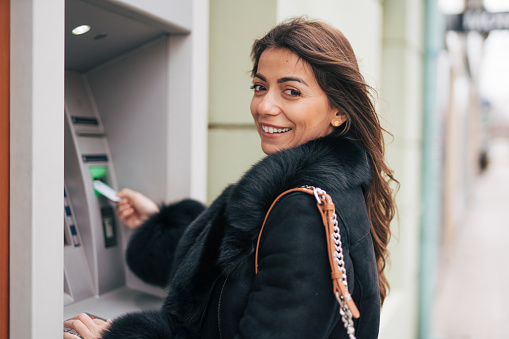 Young woman using a cash machine