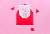 a red envelope that says hold me close to you on a pink background surrounded by