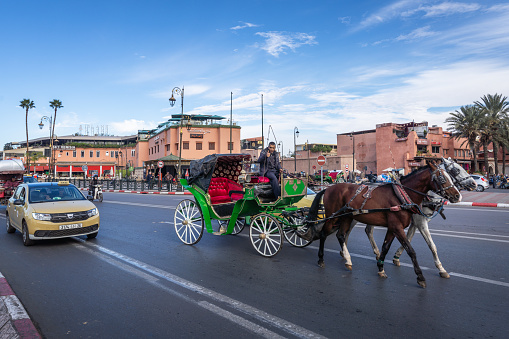 Marrakesh, Morocco - January 6, 2024: A carriage on the street of Marrakesh carries tourists