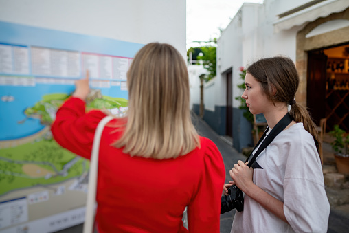 Family of tourists studies a map of the old city.